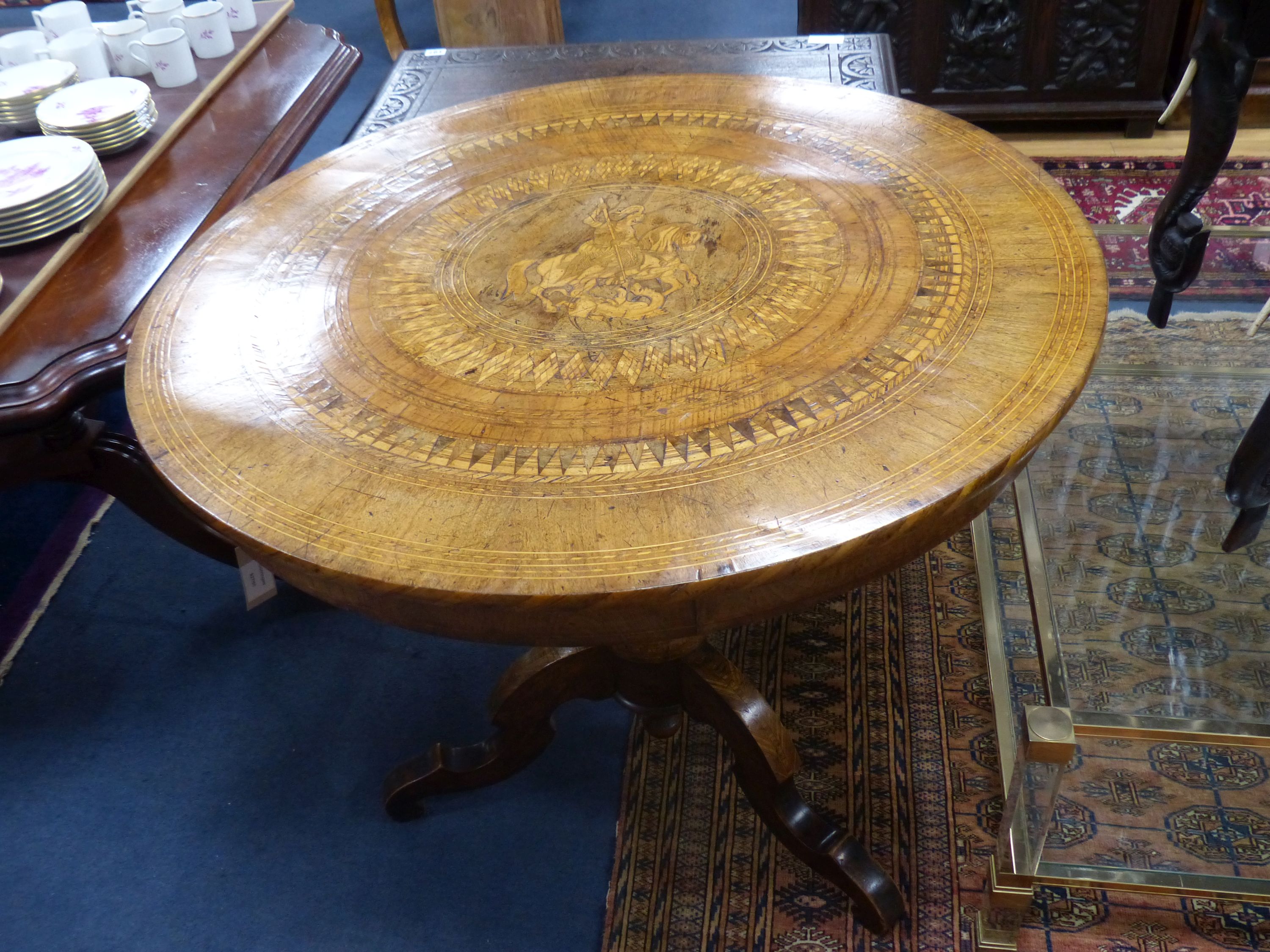 A 19th century Sorrento inlaid table, decorated centrally with a scene of St. George slaying the dragon, diameter 89cm, height 77cm